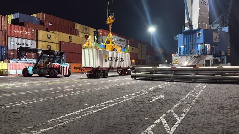 Clarion container being handled at a West African port at night